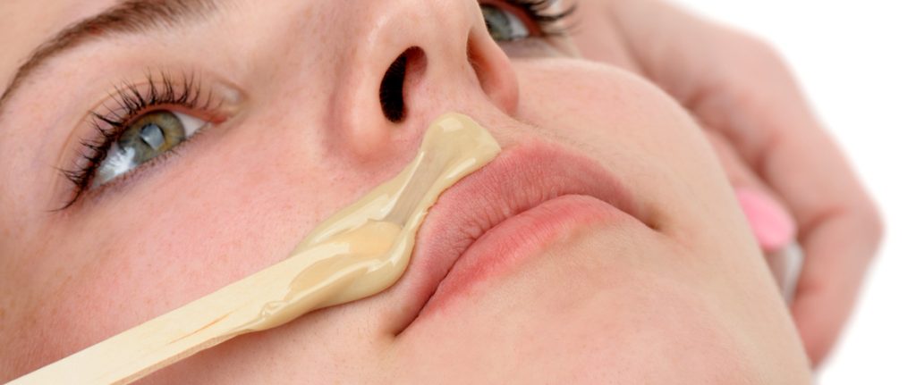 A woman getting hair removed from her upper lip.